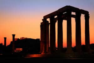 The Temple of Olympian Zeus after sunset, with Acropolis in the background.