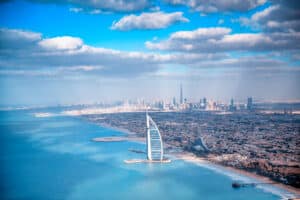 Aerial view of Downtown Dubai and Burj Al Arab from helicopter at sunset