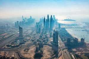 Dubai aerial view of marina skyscrapers and jumeirah beach at sunset. Helicopter view