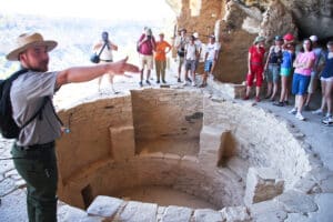 A Park Ranger lectures visitors to Cliff Palace, Mesa Verde National Park