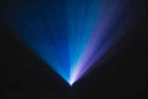 Blue and violet laser beams in dark venue